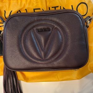 Brand new. Never used. Tags included. Very dark purple